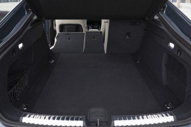 Audi A5 cargo area, with one of the rear seats in place but the other two folded flat.