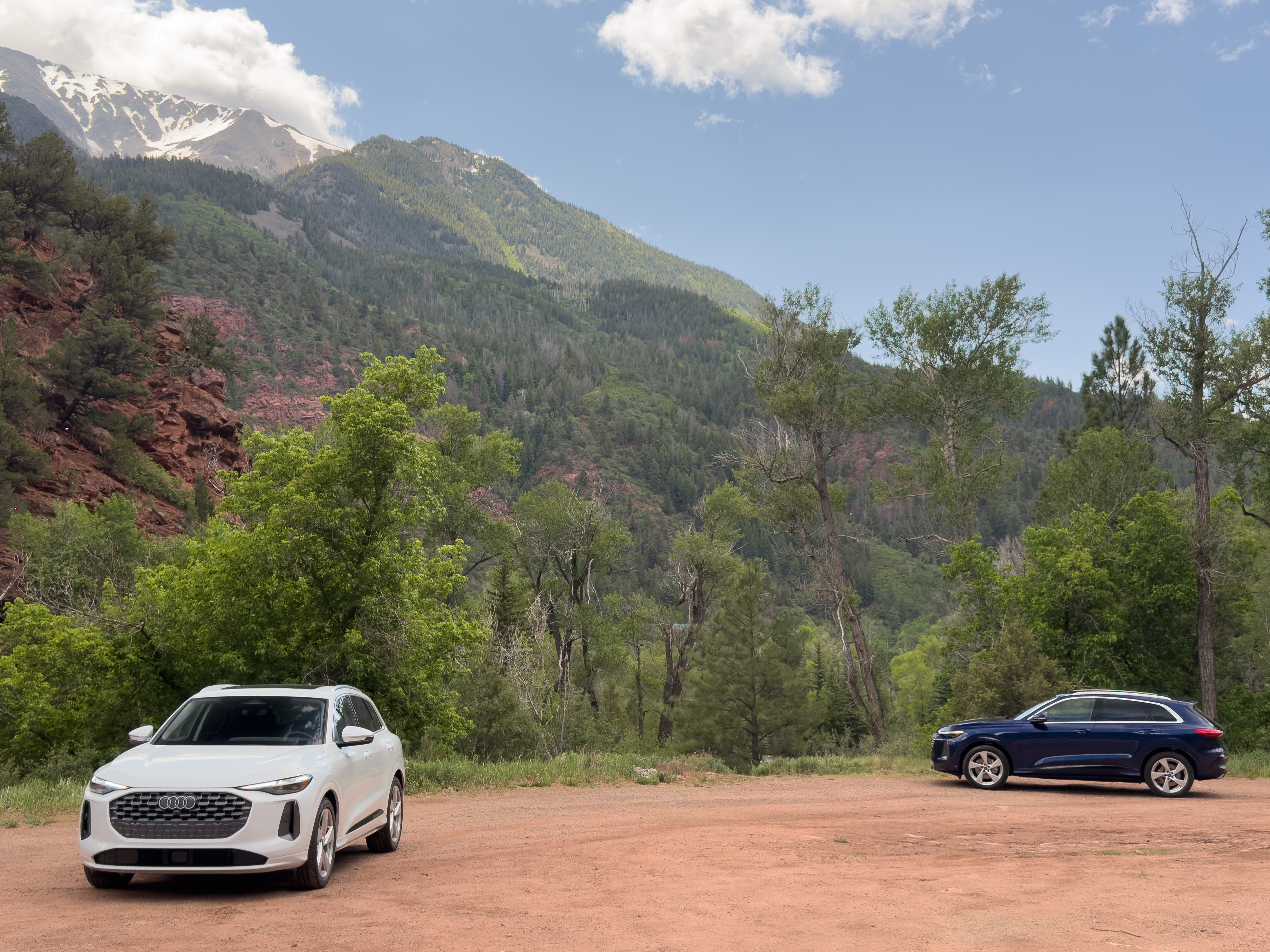 A pair of Audi Q5s parked by some mountain scenery