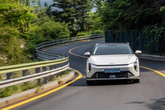 A Kia EV4 on a winding road.