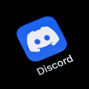 The Discord application app for instant messaging, chat, voice conferencing and video conferencing can be seen on the display of an iPhone