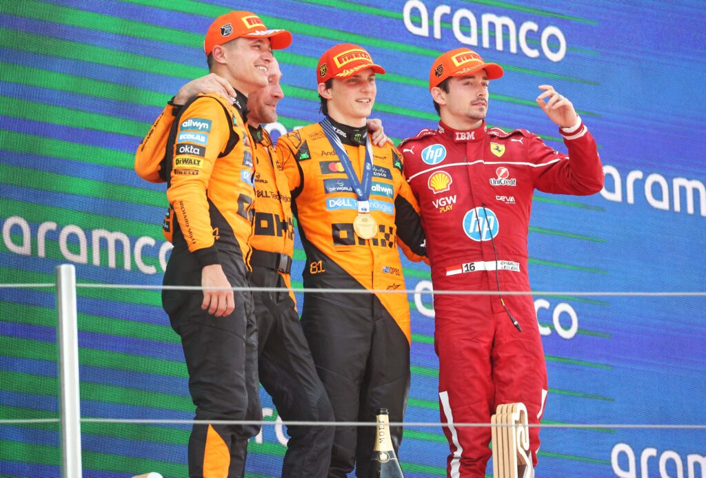 Oscar Piastri, Lando Norris, and Charles Leclerc stand on the podium after finishing first and second at the Formula 1 Aramco Grand Prix of Spain at Circuit de Barcelona-Catalunya in Barcelona, Spain, on June 1, 2025.