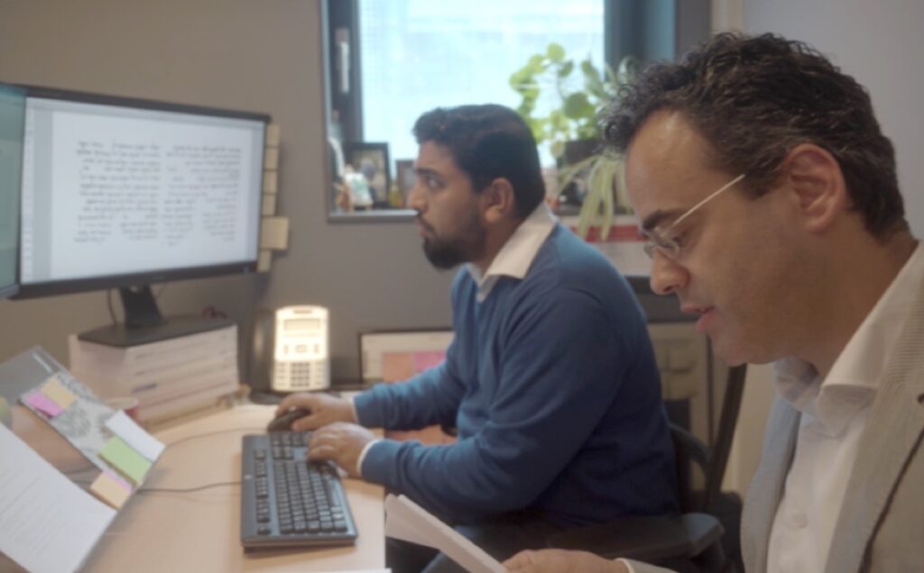 Mladen Popovic and Maruf Dhali working with Enoch to date a manuscript from the Dead Sea scrolls.