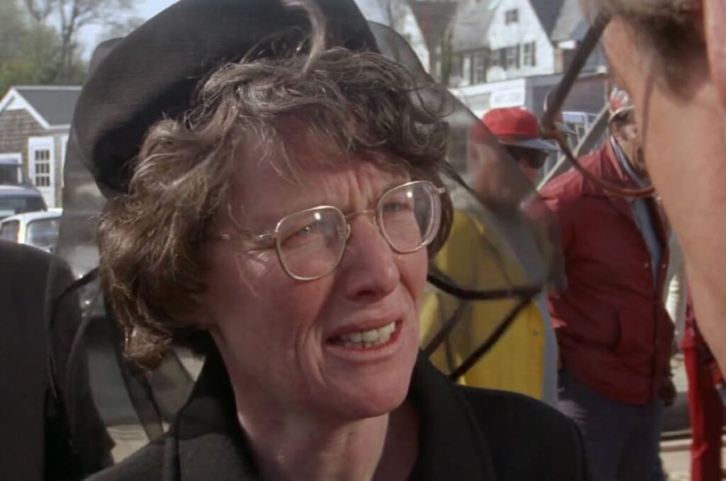 middle aged woman in glasses dressed in mourning black.