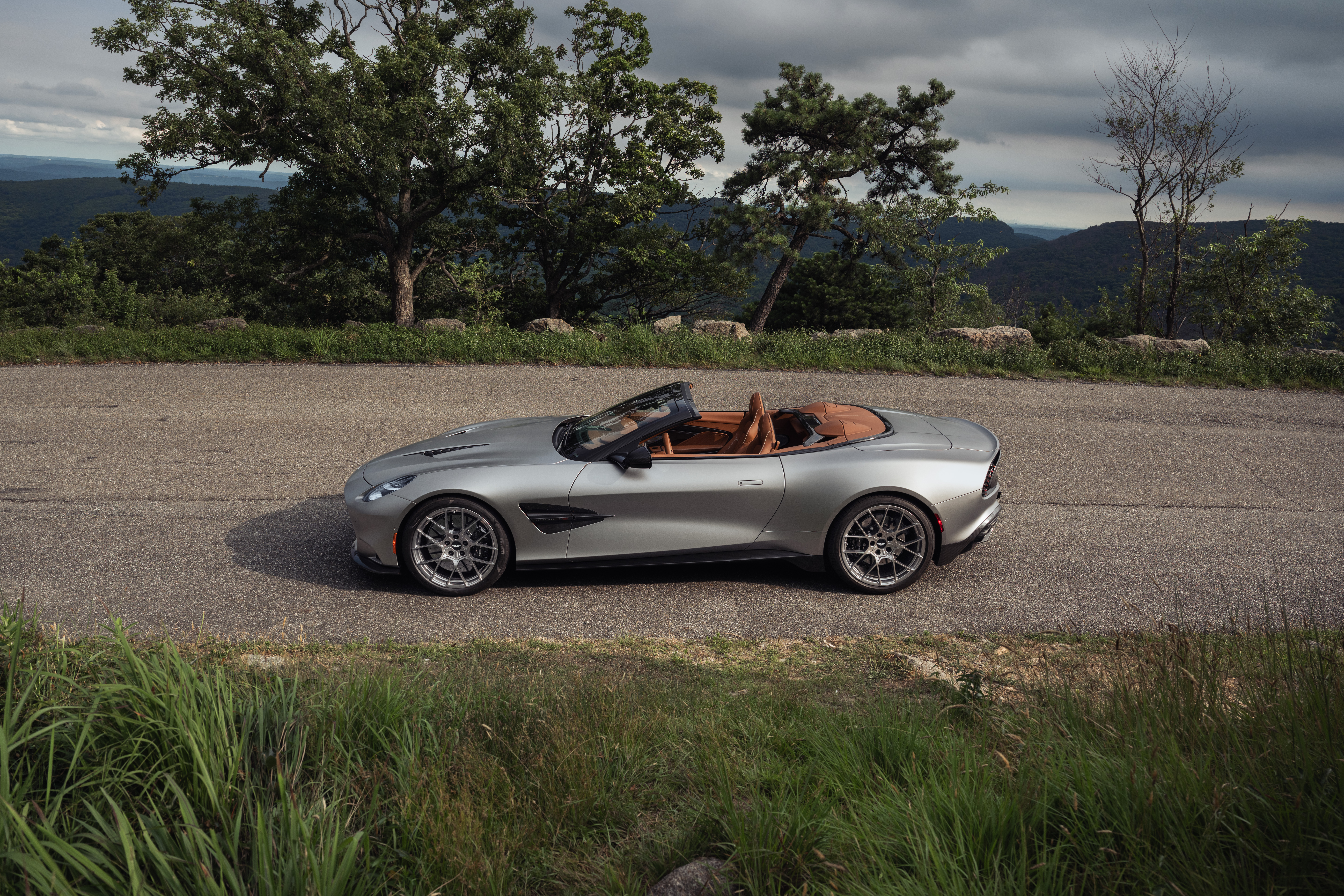 A silver Aston Martin Vanquish Volante seen in profile