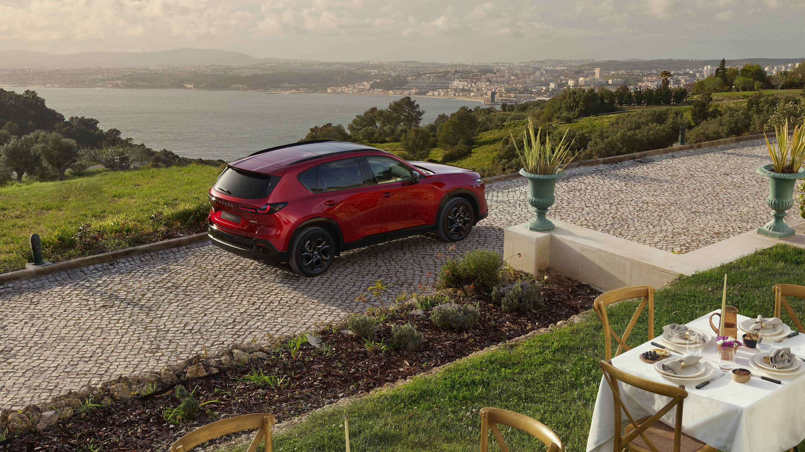 A red Mazda CX-5 seen from above and behind.