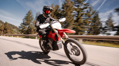 A man rides a motorbike towards the camera.