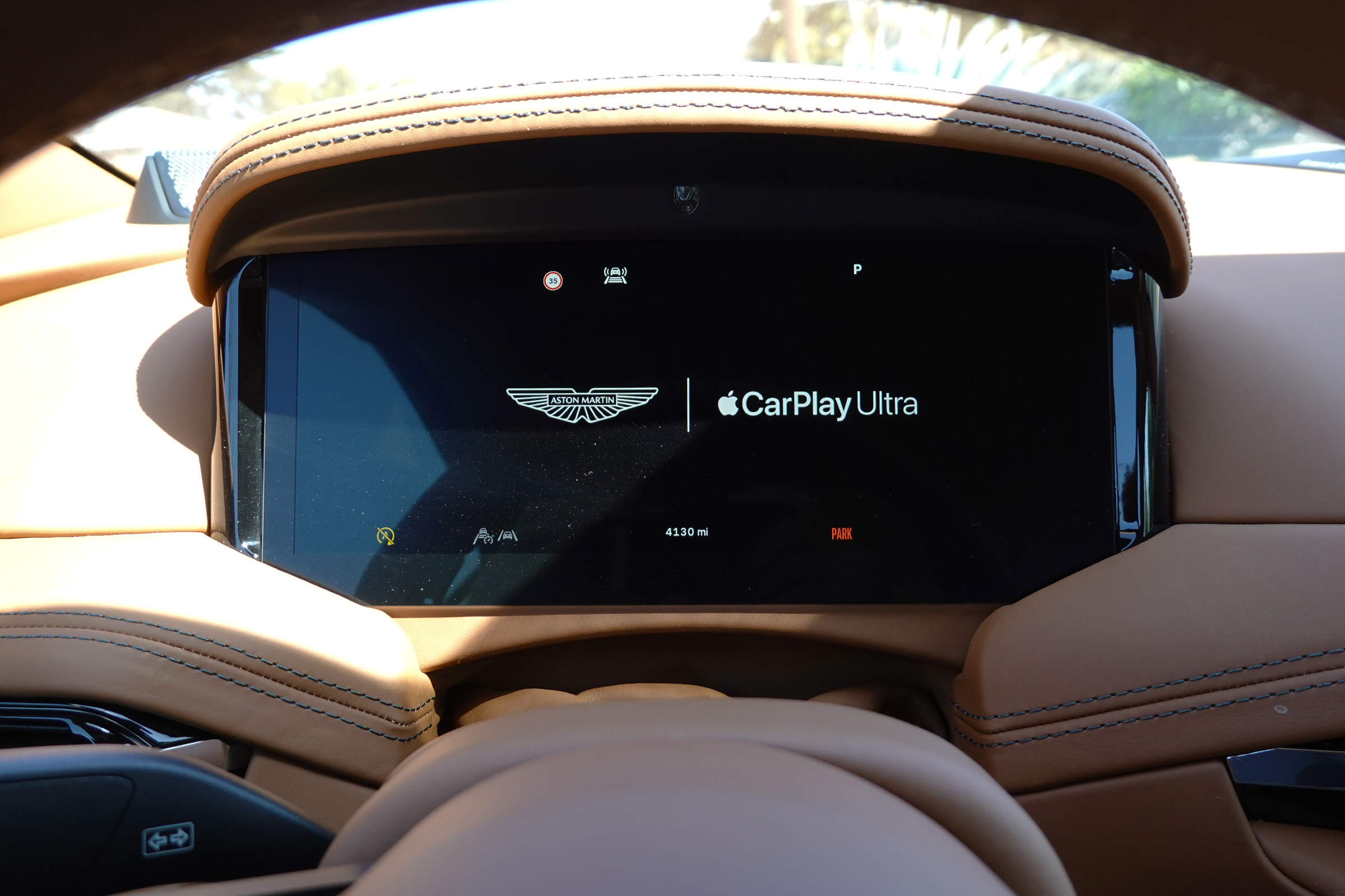 Aston Martin dashboard showing CarPlay ultra logo