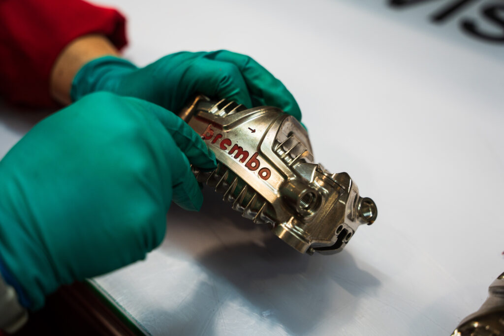 A gold-painted Brembo brake caliper.