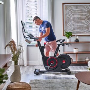 Someone adjusting their Echelon Connect EX-5s-22 bike.