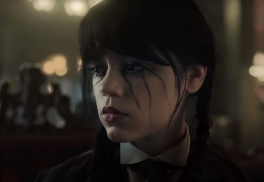 dark haired girl with pigtails with black tear streaks running down her face.