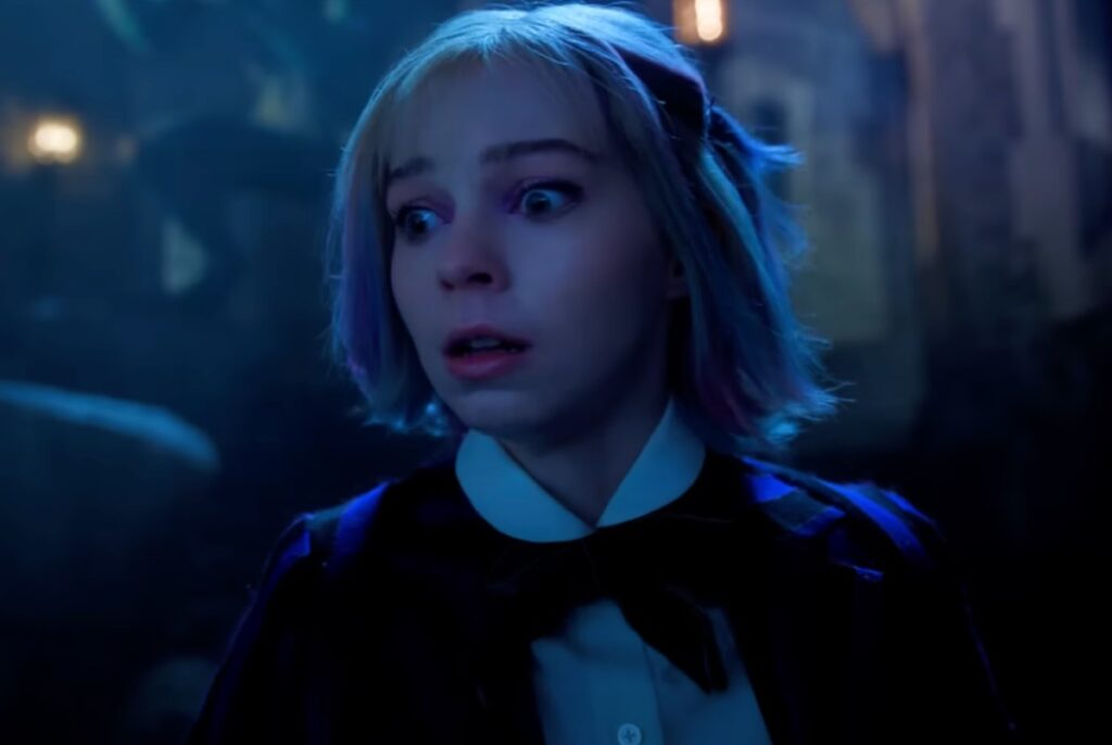 pretty blonde girl at night looking alarmed.