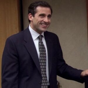 Michael Scott next to a TV on a cart in The Office.