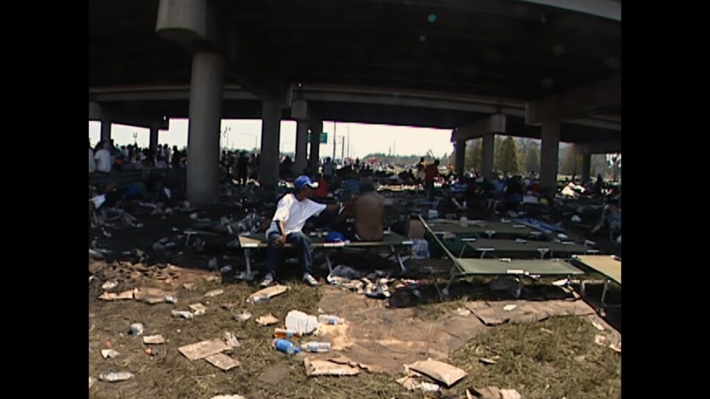 Stranded New Orleans residents gather underneath the interstate.