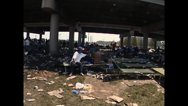 Stranded New Orleans residents gather underneath the interstate.