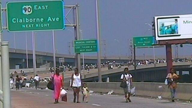 New Orleans residents walk down the interstate trying to find refuge.