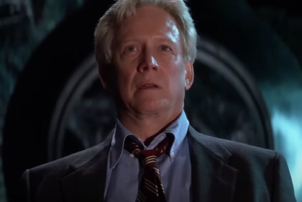 clearcut white haired man in power suit looking alarmed.