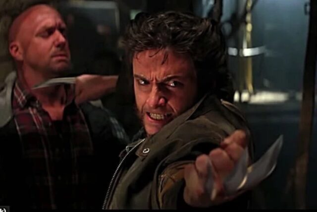 dark haired man with sideburns and claws coming out of his hands holds one against the throat of an attacked and points the other at a second attacker