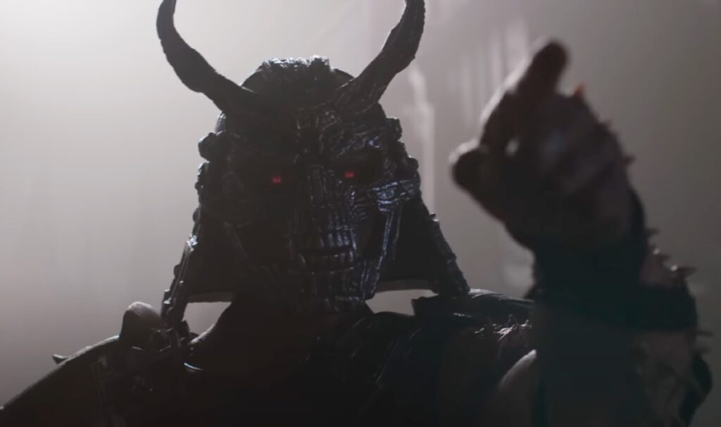 satanic looking monster with horns raising a fist,