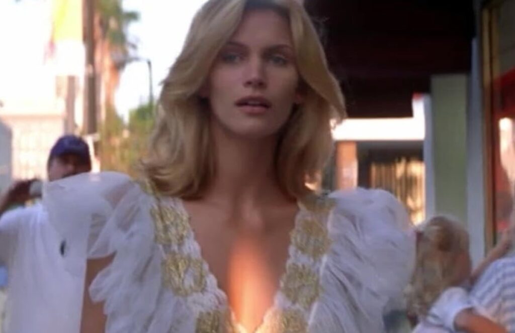 stunning blonde woman in white dress walking down an LA street.