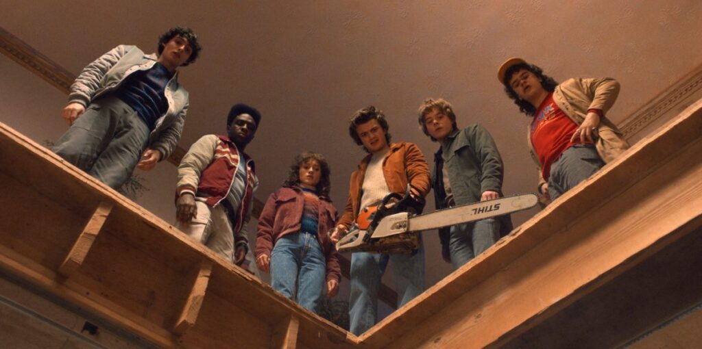 line of young adults standing above an opening in the floor looking down
