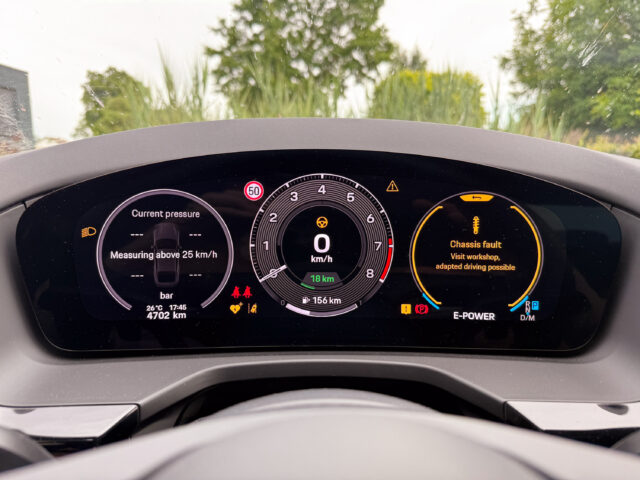 Porsche Panamera main instrument display showing an active suspension failure and saying go to a dealer