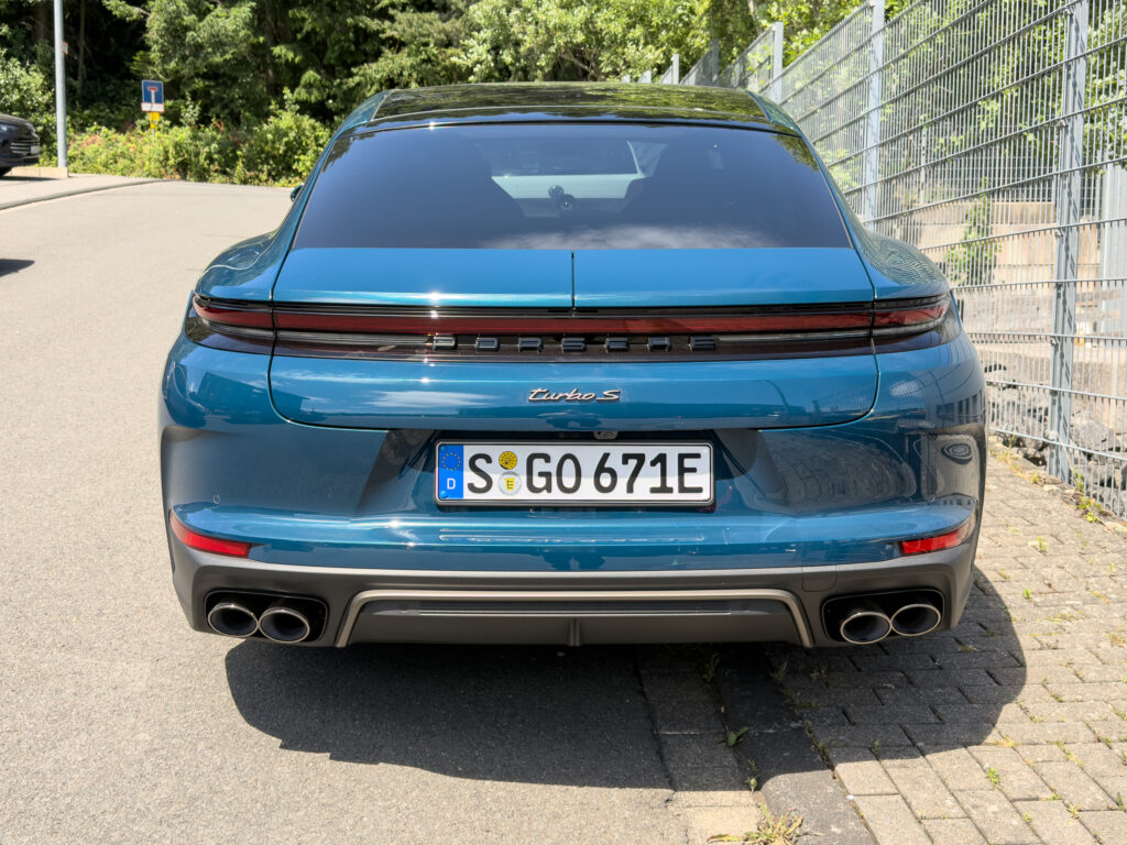 A blue Porsche Panamera Turbo S from behind.