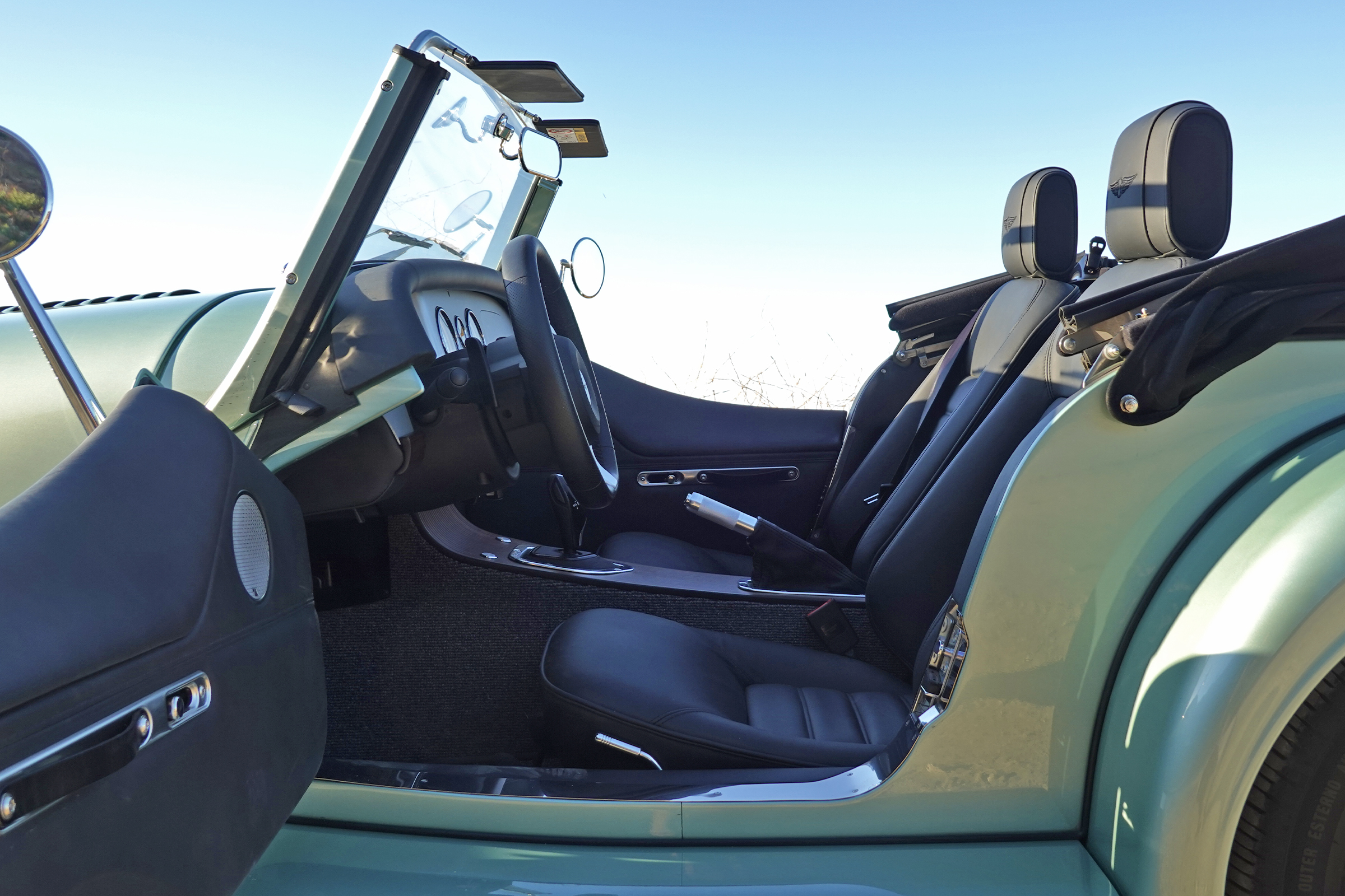 A Morgan Plus Four with the door open