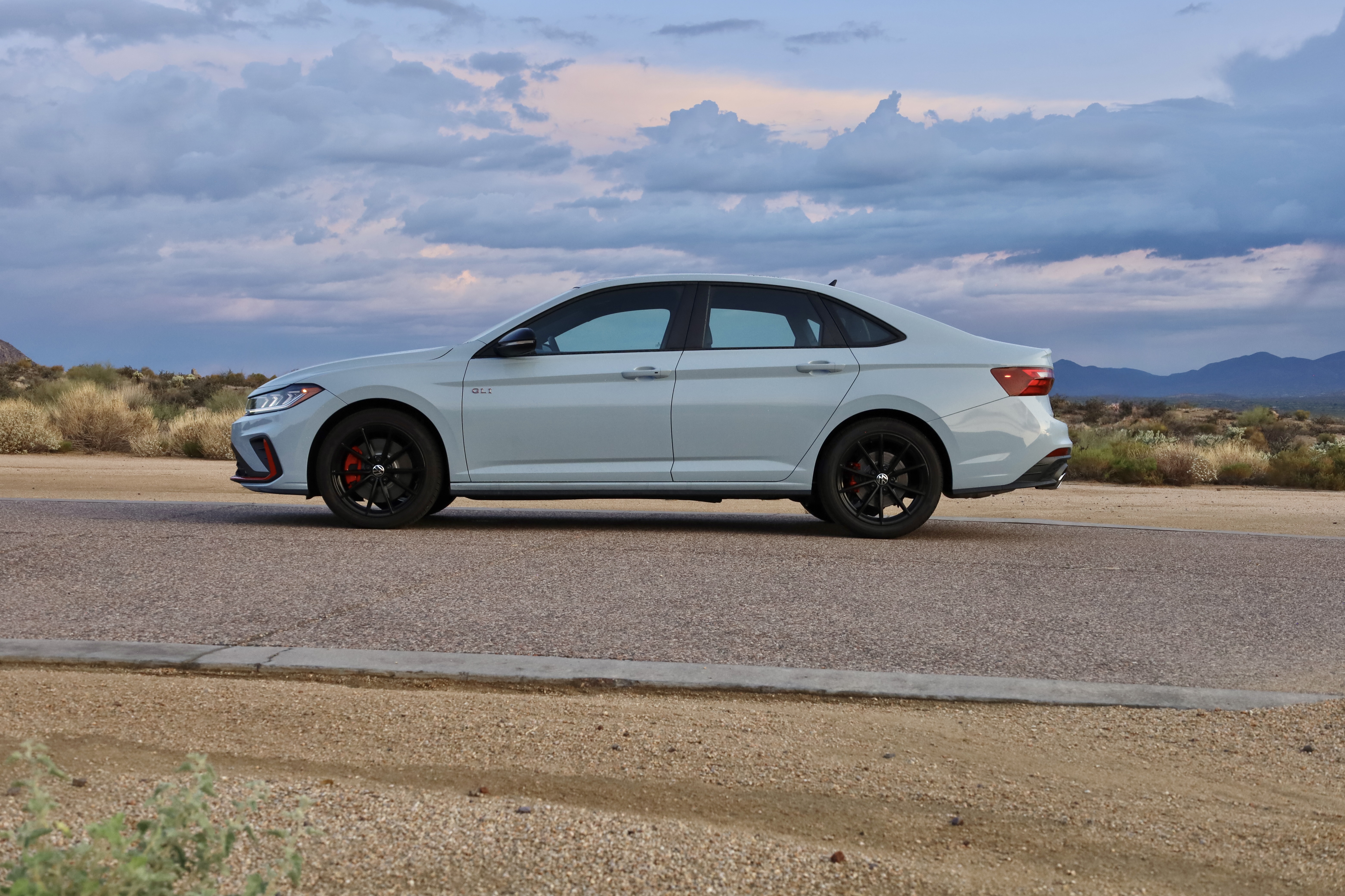 A white VW Jetta in profile