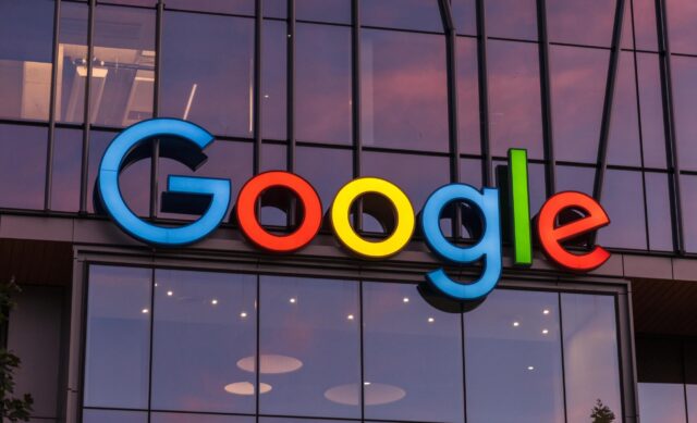 A large Google logo on the outside of a company building.