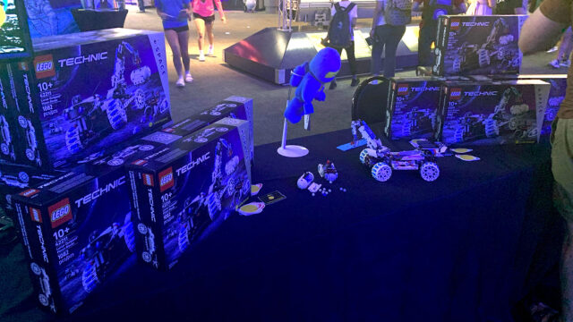 building brick toys shaped as moon rovers on display in a blue-tinted dimly-lit room