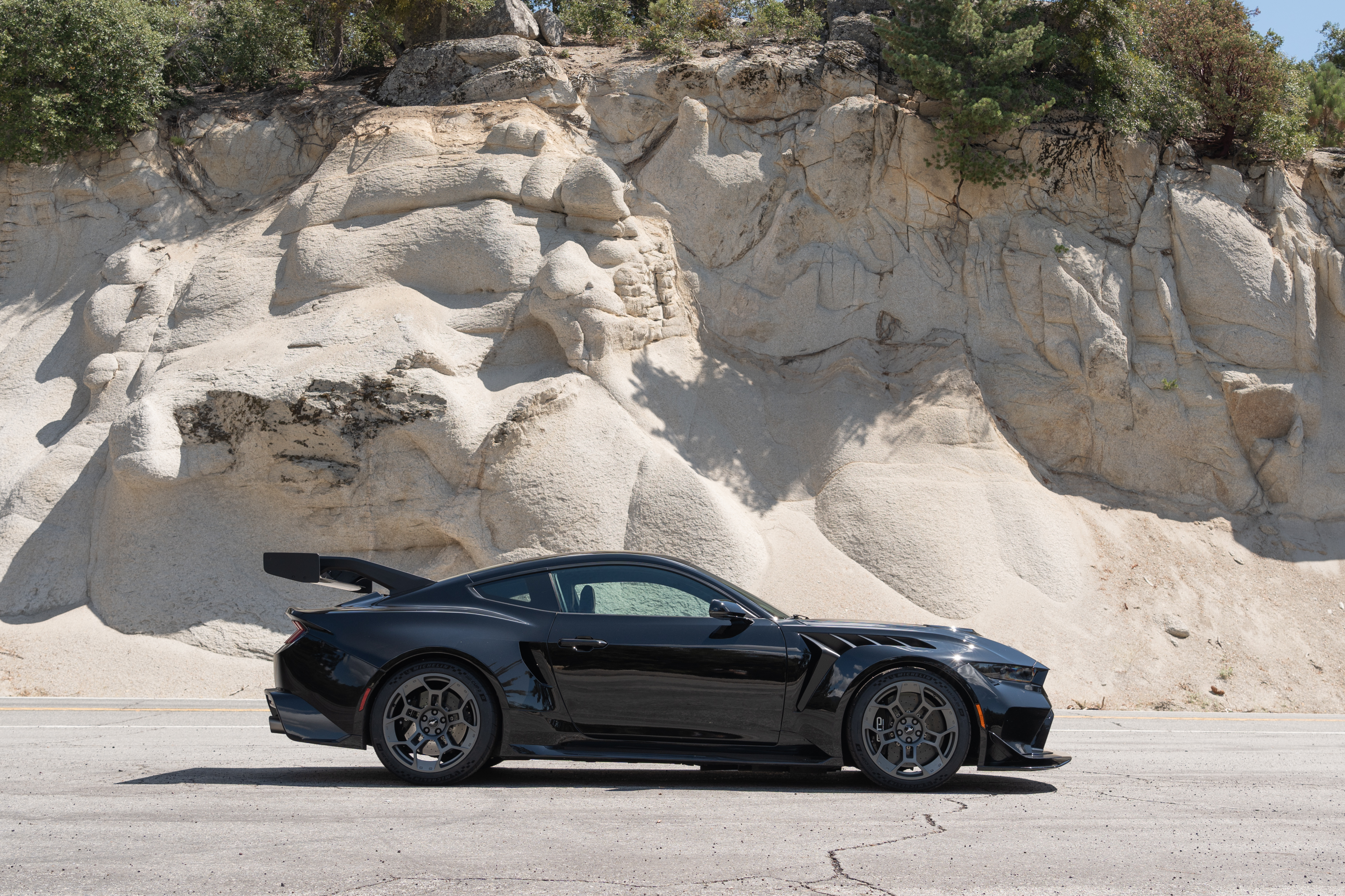A black Ford Mustang GTD in profile.