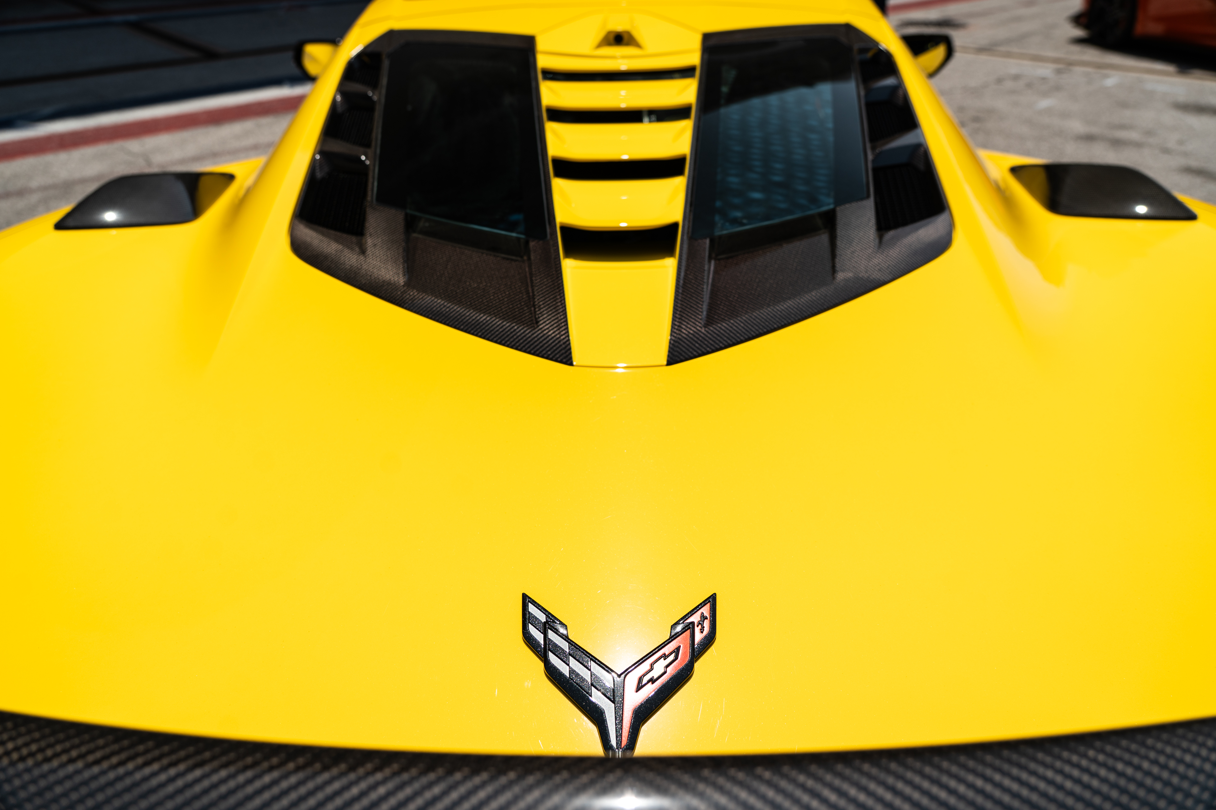 The engine bay of a yellow Corvette ZR1.