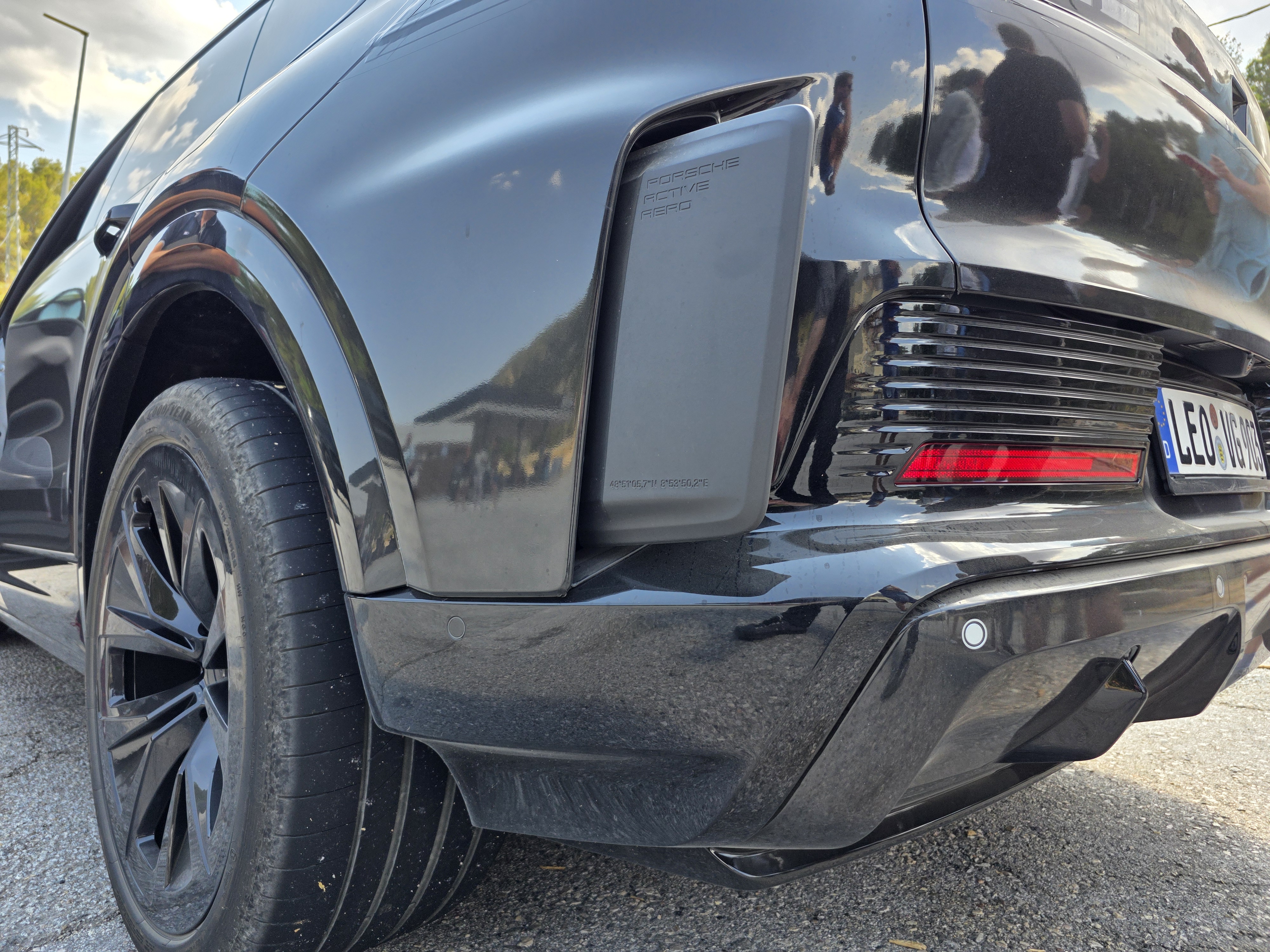 An active aerodynamic element extended from the side of the Porsche Cayenne Electric's rear bumper