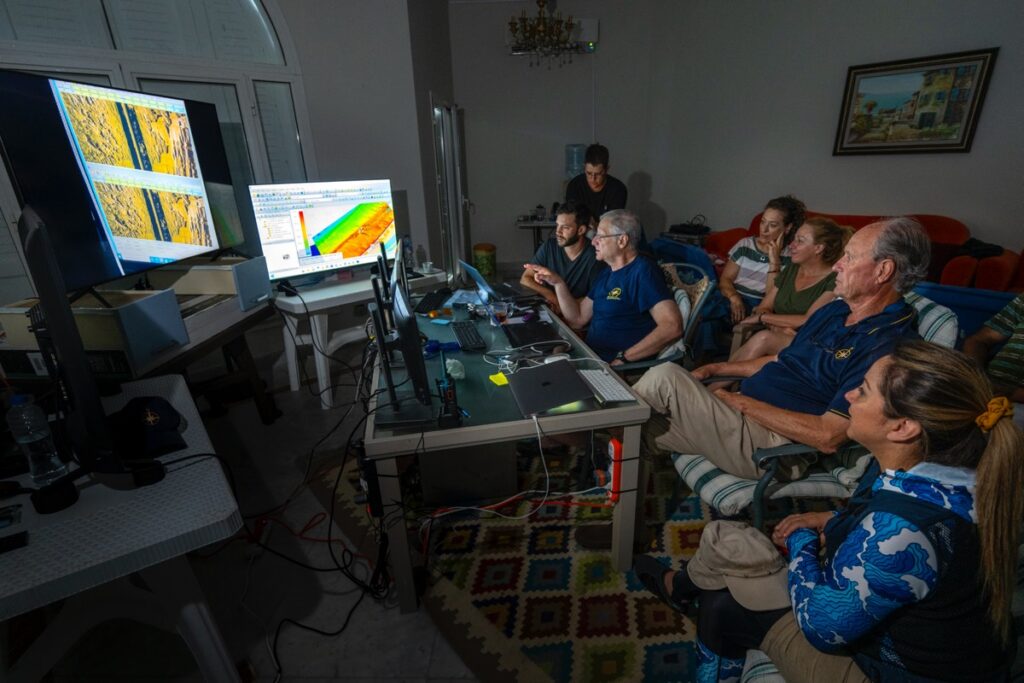 Martinez, Ballard, and the team look at seafloor scans.