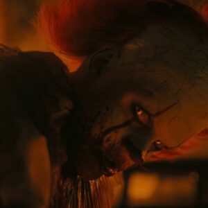 closeup of sinister clown giving an evil smile to the camera