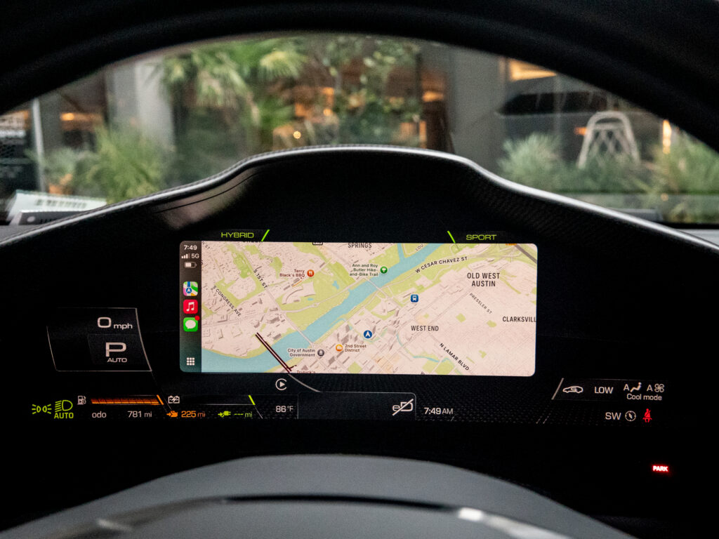 Ferrari 296 GTB driver display showing apple CarPlay and Apple Maps