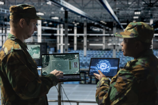 Team of military experts in a data center analyzing missile flight paths with deep learning tools.