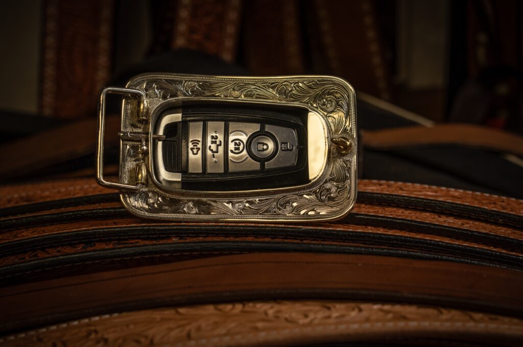 The back side of a belt buckle that has a key fob holder in it
