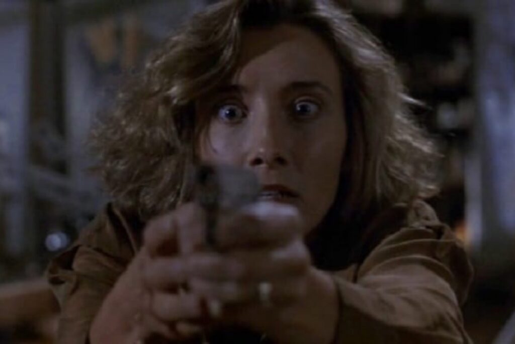young woman, frightened, pointing gun at the camera