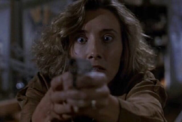 young woman, frightened, pointing gun at the camera