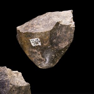 Photo of 3 chunks of stone with flakes chipped off to make sharp edges