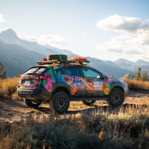 A brightly colored Subaru Crosstrek Wilderness rally car