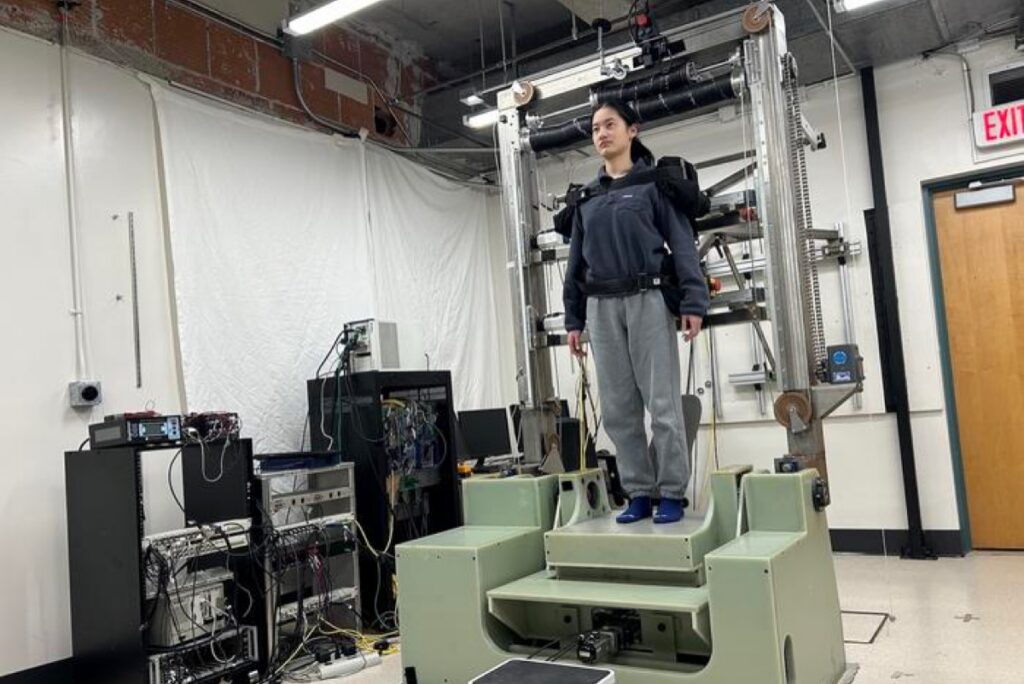 Participant standing on body-swap balance robot