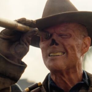 ghoul in cowboy hat with missing nose looking through a small telescope