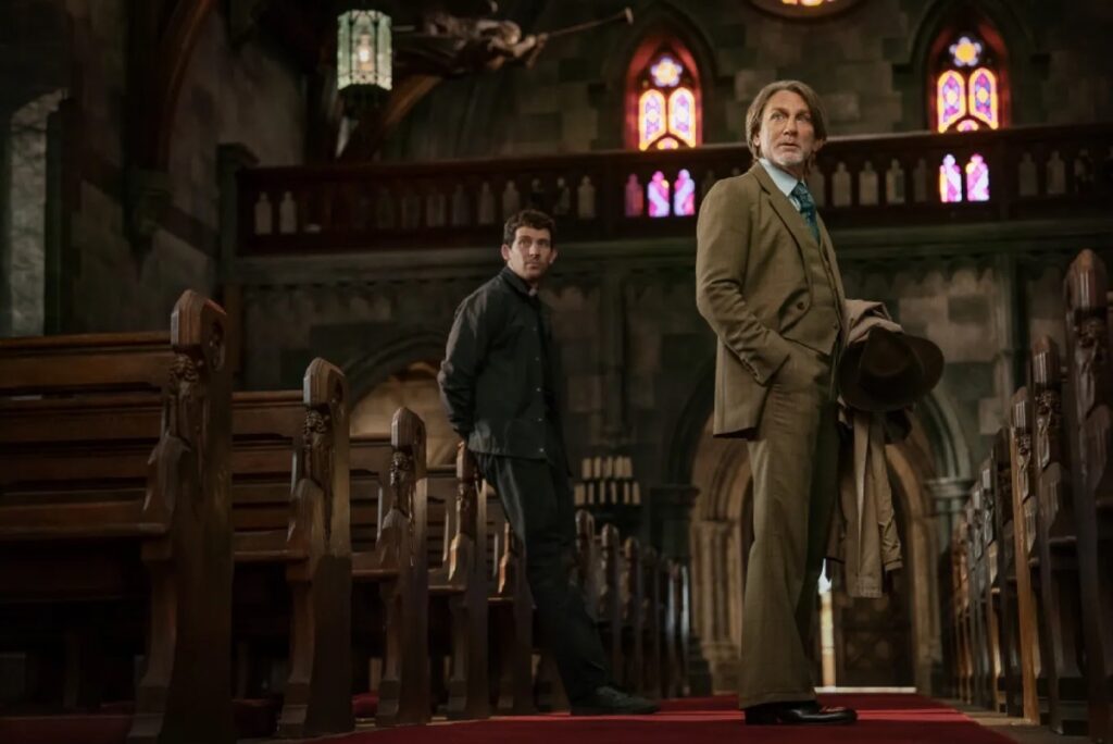 a dapper detective standing in interior of a Gothic style church with a priest and other people in the background