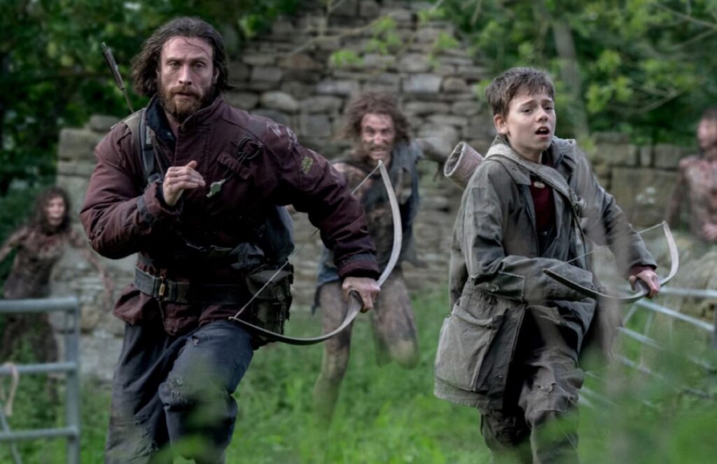man and his son running away from zombies in a field