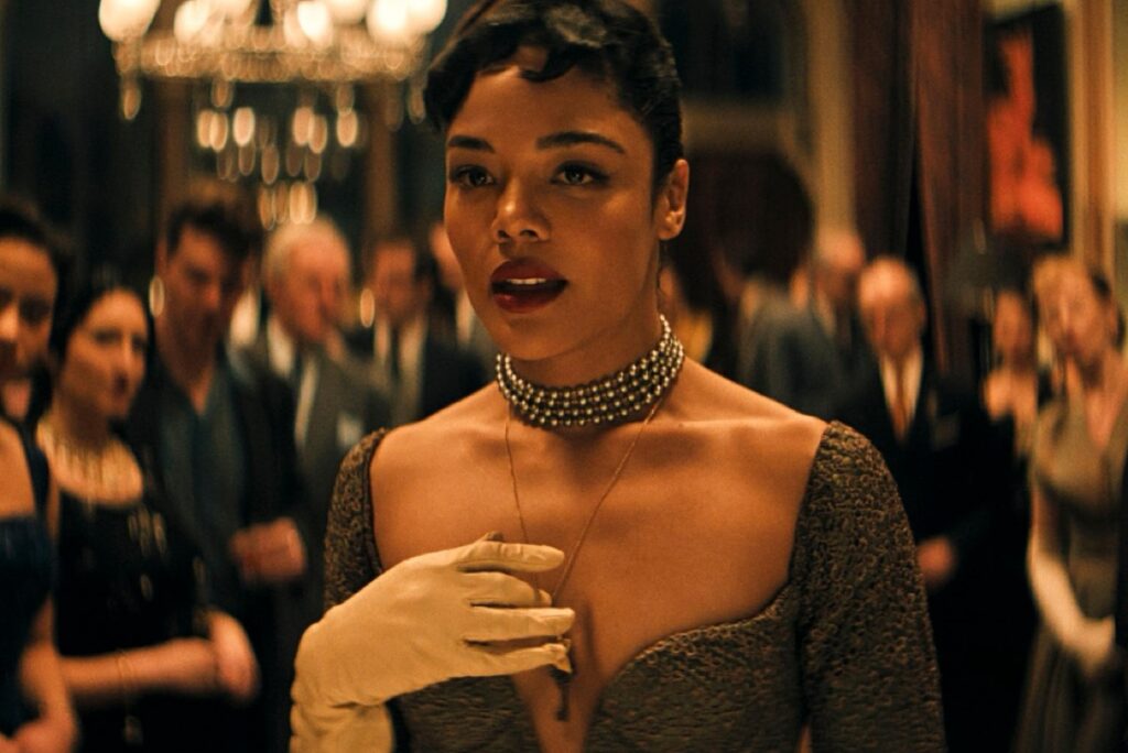 young black woman in a ball gown surrounded by party guests