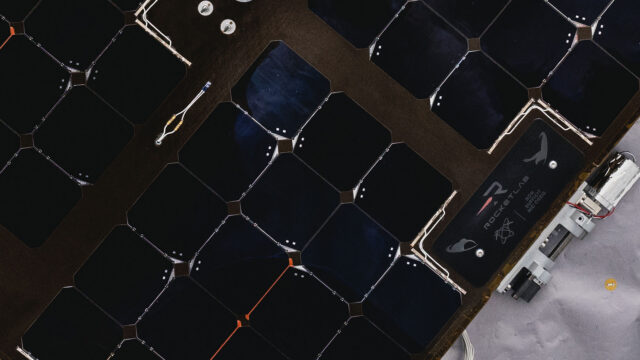 Close up photo of a commemorative plaque attached to a spacecraft's solar array