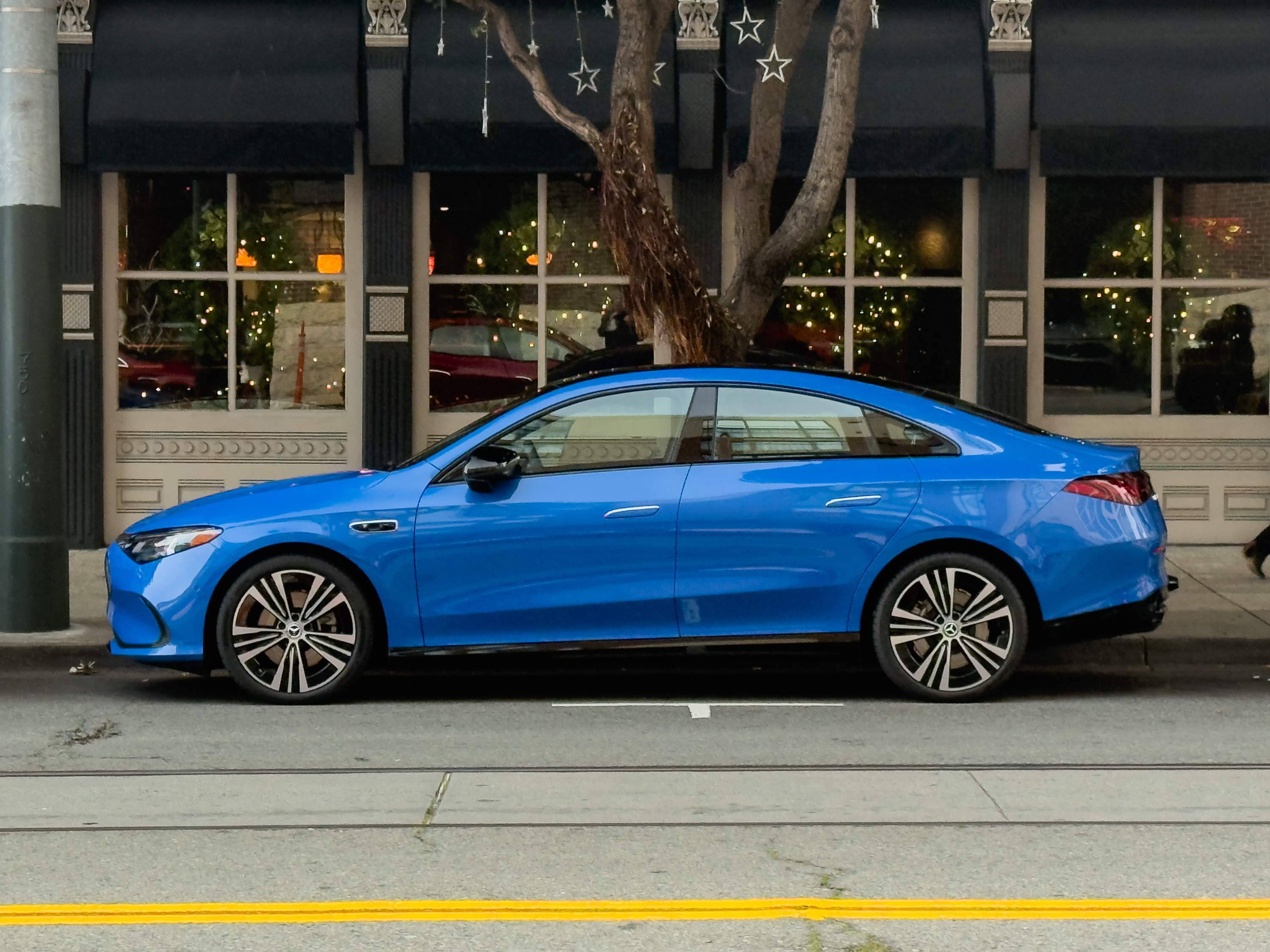 A blue Mercedes-Benz CLA parked in profile