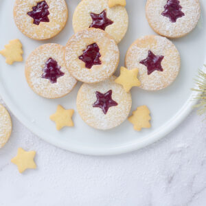 linzer cookies on a plate on a marble countertop